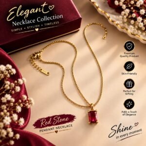 Elegant red stone pendant necklace with gold-tone chain on a luxury display background.